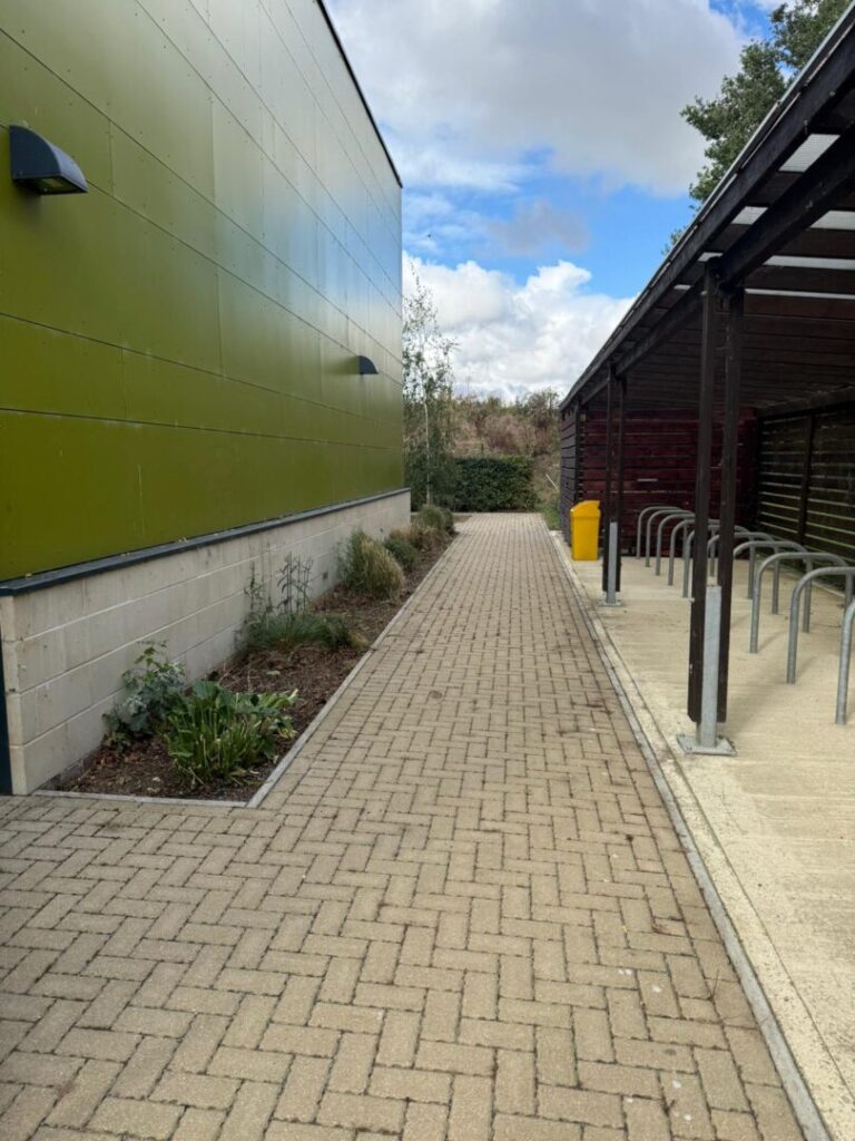 contracted grounds maintenance service near bike parking rack and building