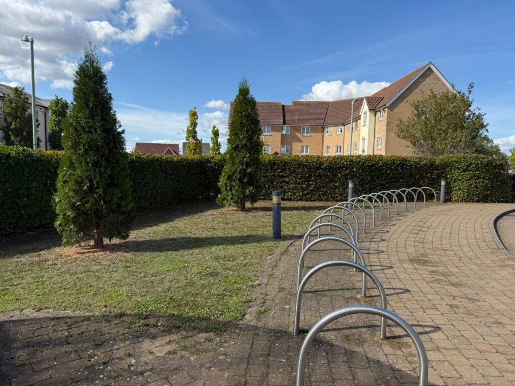 grass cutting and mowing next to bike parking rack