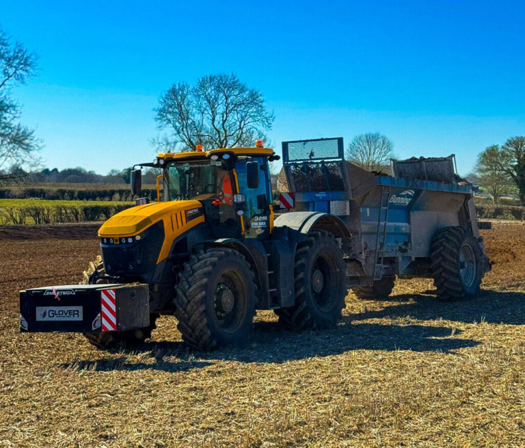 yellow tractor spreading