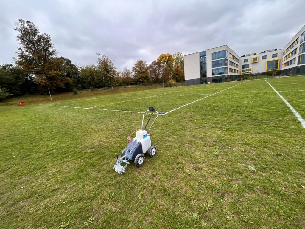 field marker machine on sports pitch outside school