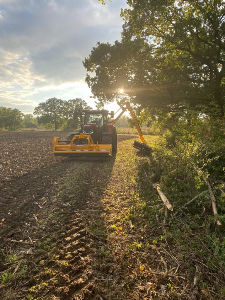 hedge cutting in progress on farm land